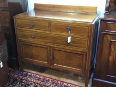 An Edwardian mahogany wash stand style ledgeback chest, the top with boxwood strung border above two