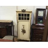 A late 19thc French partial gilt side cabinet with flaming torch surmount and glazed inset panel