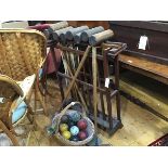 An Edwardian pine croquet mallet stand complete with ten various mallets, metal hoops and a basket