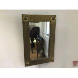 A brass rectangular wall mirror, with bevelled glass plate and stylised hammered diamond finish (