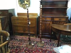 A pair of Eastern teak carved tapered column floor lamps raised on circular moulded bases (h.124cm)