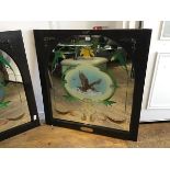 An arched reverse painted pub mirror with daffodil and scroll leaf cartouches, of a golden eagle,