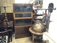 A Globe Wernicke style four section sectional walnut bookcase with three glazed hinged up and over