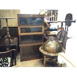 A Globe Wernicke style four section sectional walnut bookcase with three glazed hinged up and over