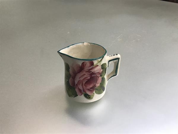 A Wemyss ware Scottish pottery cabbage rose decorated miniature milk jug, signed verso (natural