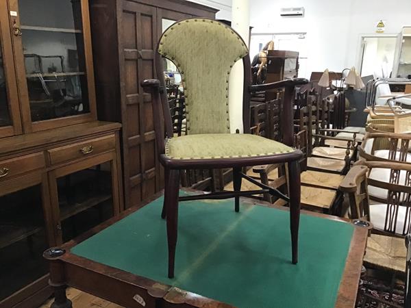 A stained upholstered panel back Edwardian open armchair with inset seat, on tapered supports (h.