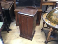 An Edwardian walnut ledgeback bedside/pot cupboard, the top with moulded edge above an inset panel