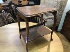 A figured walnut two tier occasional table, raised on scroll supports (h.49cm x 42cm x 30cm)