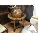 A modern novelty terrestrial style globe with hinged lift up top enclosing a mini bar fitted
