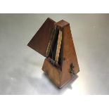 A Maelzel Paquet 1846-1915 walnut cased pyramid shaped metronome raised on bun feet, no. 895,538,