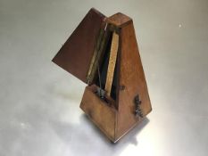 A Maelzel Paquet 1846-1915 walnut cased pyramid shaped metronome raised on bun feet, no. 895,538,