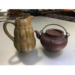 A Japanese pottery teapot with bronze style metal loop handle, signed to top and verso (10cm) and