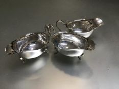 A set of three Birmingham silver George III style scalloped sauceboats, raised on pad feet (324.