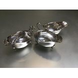 A set of three Birmingham silver George III style scalloped sauceboats, raised on pad feet (324.