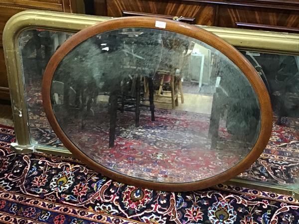 A Victorian mahogany inlaid oval wall mirror with bevelled glass plate (74cm x 94cm)
