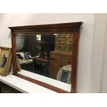 A yew wood wall mirror, the rectangular moulded top above a brass mounted frieze with rectangular