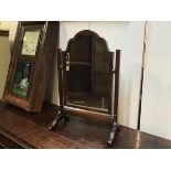 An oak frame swing mirror with arched top on square section supports (h.62cm x 40cm)