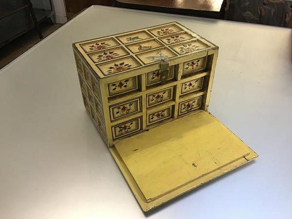 An Indian painted miniature table chest with panelled coffered front with painted birds, animals