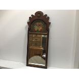 A reproduction walnut fretwork Queen Anne style arched mirror with shell surmount and painted