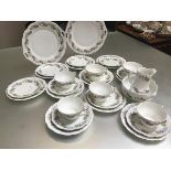 A late 19thc Continental thirty piece teaset with violet and leaf decoration complete with cups,