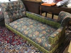 An Edwardian oak chaise longue with upholstered panel back and button scroll arm, in tapestry