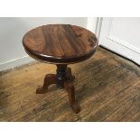 An Eastern hardwood circular top occasional table, the top with moulded edge raised on turned column