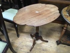 A 19thc mahogany shaped top occasional table raised on turned column and tripod support (h.70cm x