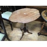 A 19thc mahogany shaped top occasional table raised on turned column and tripod support (h.70cm x