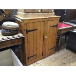 A 19thc stripped pine tongue and groove twin panel door cabinet, the top with moulded edge, raised