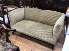 An Edwardian mahogany club style two seater sofa with upholstered panel back, arms and seat, in