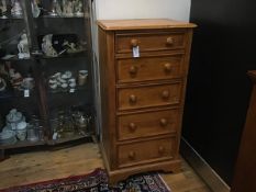 Willis Gambier, Bishops Stortford, a stained pine upright tallboy chest, the top with moulded edge