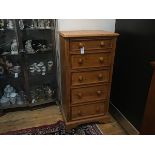 Willis Gambier, Bishops Stortford, a stained pine upright tallboy chest, the top with moulded edge