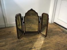 A 1920s walnut triple dressing mirror with Queen Anne style arched moulded frame with shell