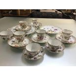 A Dresden china sixteen piece tea service with fluted spiral tapered cups and lobed saucers, a