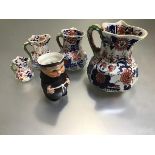 A set of four Masons Ironstone octagonal Imari decorated jugs with dragon scroll handles and a