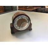 A Davall 1920s oak eight day mantle clock with arched cased and silvered dial with roman numerals