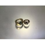 A 9ct gold bombe style ring (4.06g) and a yellow metal ring, unmarked (4.35g)