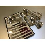 A set of six Epns tea knives with red handles, a part set of Epns bead pattern table spoons, dessert