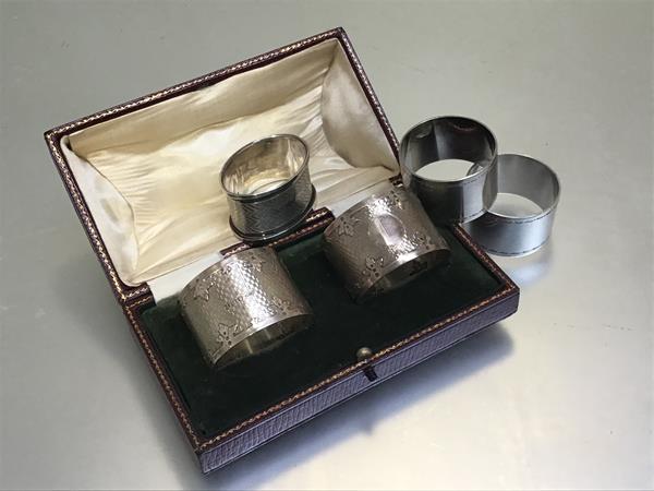 A pair of Birmingham silver engine turned napkin rings, two Epns napkin rings and a Birmingham