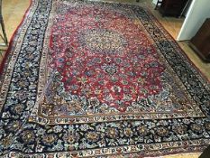 An Iranian Mashad carpet, the central radiating lotus flower and palmette medallion enclosed