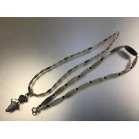 A polished hardstone graduated bead necklace of lozenge form (20cm) and a polished agate and