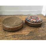 Two Victorian walnut inlaid circular footrests with upholstered tops on ceramic fluted supports (h.
