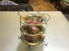 A set of three Palissy floral decorated tea plates complete with original plated cakestand (h.40cm x