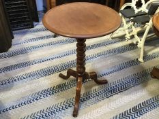 A 19thc mahogany occasional table, the saucer top raised on ring turned column and tripod support (