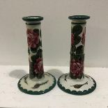 A pair of Wemyss ware style pottery candlesticks of tapered form with green decorated borders and