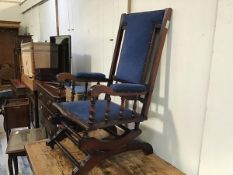 A 19thc walnut American style rocker chair with upholstered panel back, arms and seat, in blue