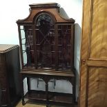 An Edwardian mahogany display cabinet, the moulded top with arched centre glazed panel door,
