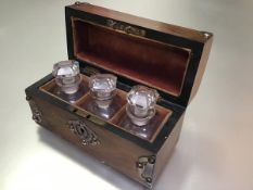 A Victorian walnut glass and metal mounted perfume dome top box including a set of three perfume