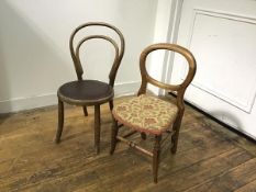 A late 19thc walnut child's hoop back chair with stuffover seat, on turned tapered splay supports