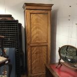 A 19thc satinwood wardrobe single section with moulded cornice and twin fielded panel door,